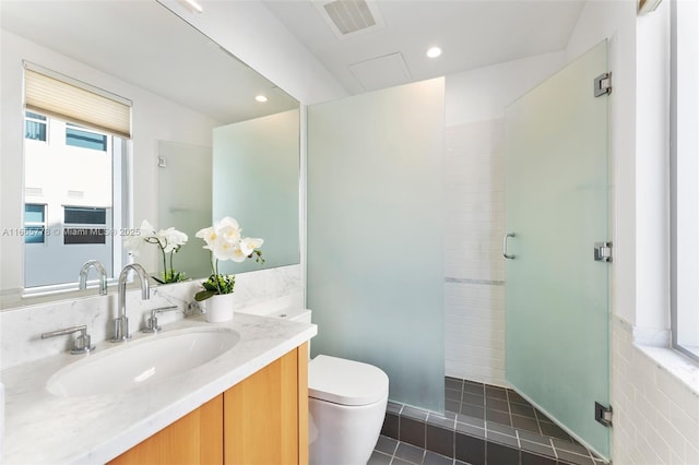 bathroom featuring vanity, toilet, tile patterned floors, and walk in shower