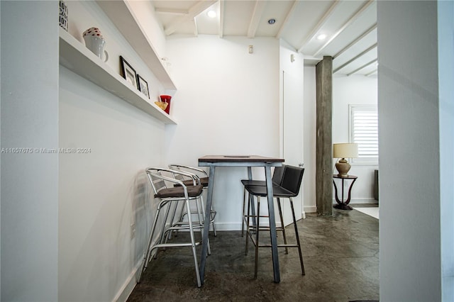 bar featuring beam ceiling