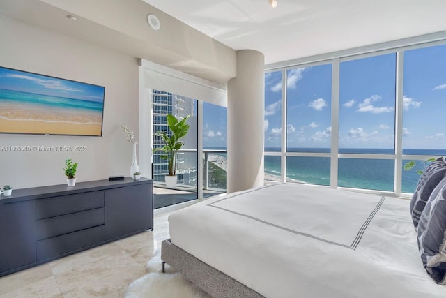 bedroom with expansive windows and a water view