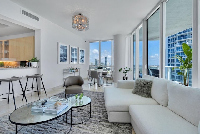 living room with a wall of windows and a chandelier