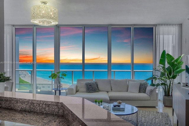 living room featuring a water view and a chandelier