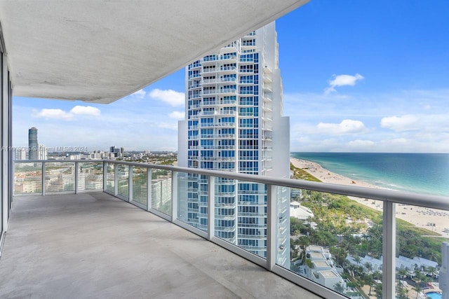 balcony featuring a water view and a view of the beach