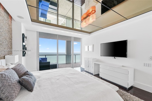 bedroom with multiple windows and hardwood / wood-style flooring