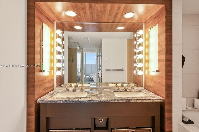 bathroom featuring wood walls and vanity