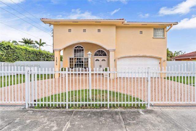 view of front of property featuring a garage and a front lawn