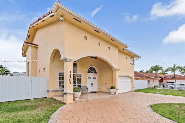 view of front of house with a garage and a front lawn