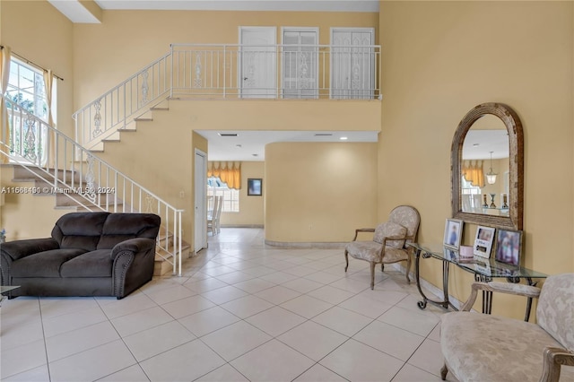 foyer with a towering ceiling and light tile patterned floors