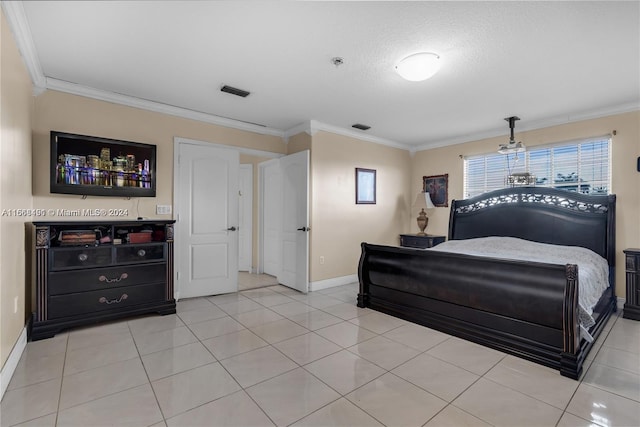 tiled bedroom featuring a textured ceiling and ornamental molding