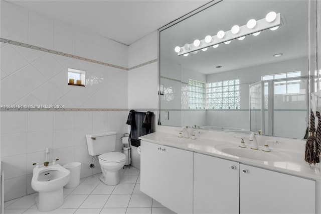 bathroom featuring tile walls, tile patterned flooring, a bidet, vanity, and toilet