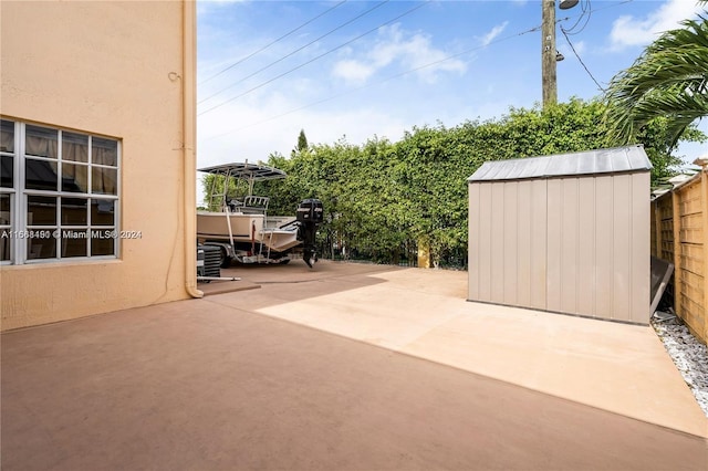 view of patio / terrace featuring a storage unit