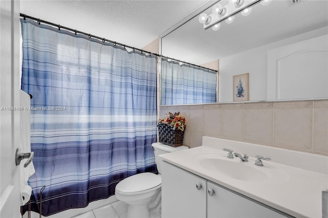 bathroom featuring tile patterned flooring, a textured ceiling, a shower with shower curtain, vanity, and toilet