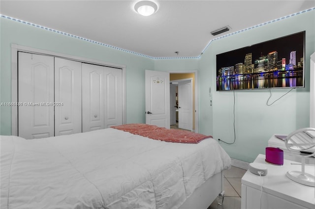 tiled bedroom featuring a closet