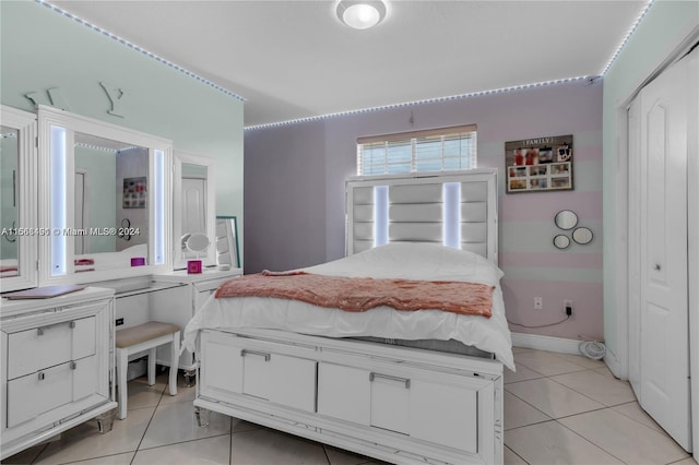 tiled bedroom with a closet