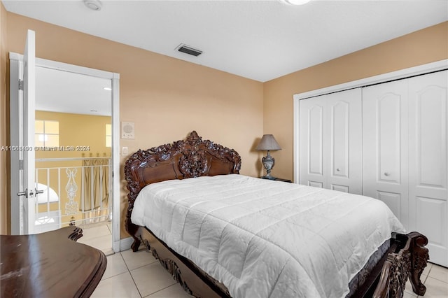 tiled bedroom with a closet