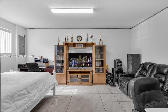 bedroom featuring electric panel and tile patterned flooring