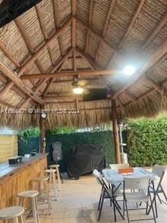 view of patio / terrace with a gazebo and an outdoor bar