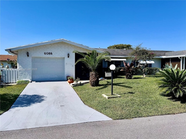 ranch-style home with a front yard, an attached garage, brick siding, and driveway