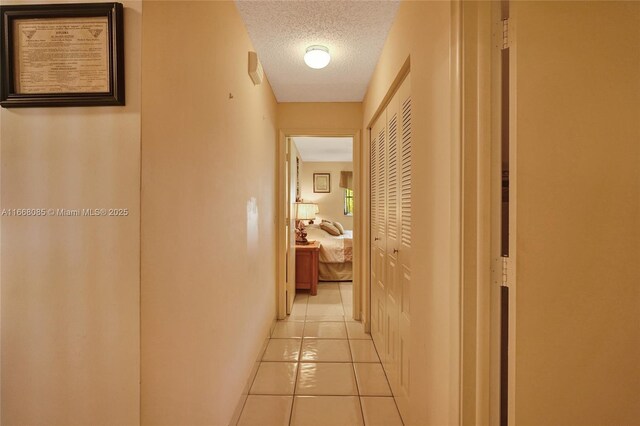 kitchen with hanging light fixtures, light stone counters, white fridge, a breakfast bar area, and decorative backsplash