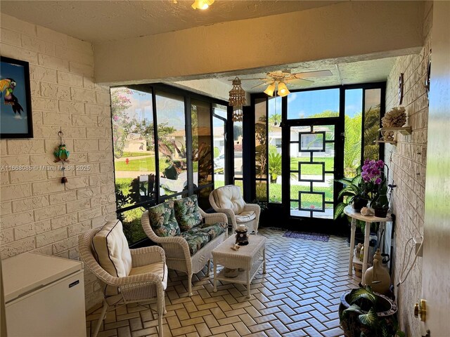 entryway with french doors, light tile patterned flooring, and a textured ceiling