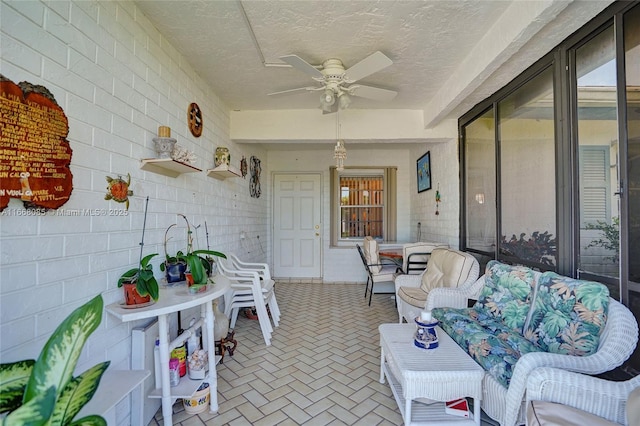 sunroom / solarium featuring ceiling fan