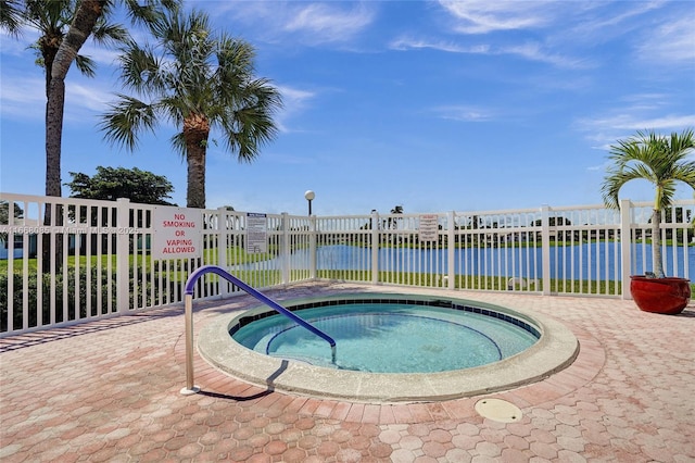 view of swimming pool featuring a water view and a community hot tub