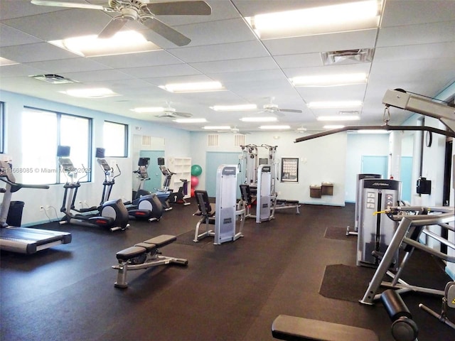 gym featuring a paneled ceiling and ceiling fan