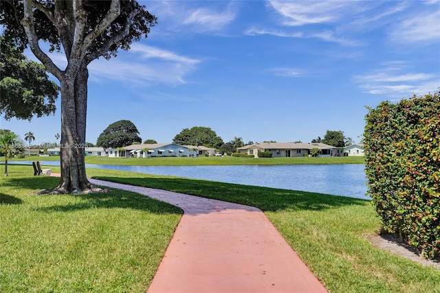 view of home's community featuring a yard and a water view