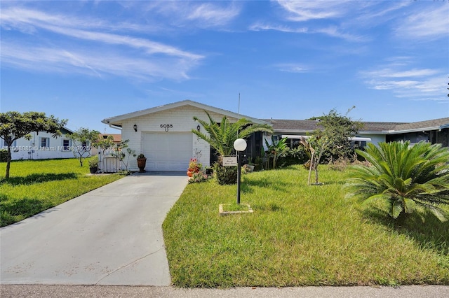 ranch-style house featuring a garage and a front yard