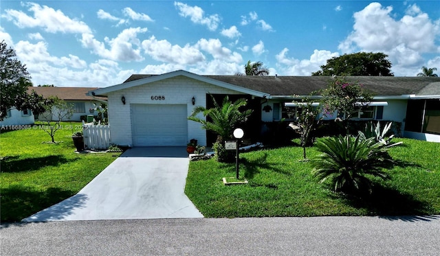 ranch-style home featuring a garage and a front yard