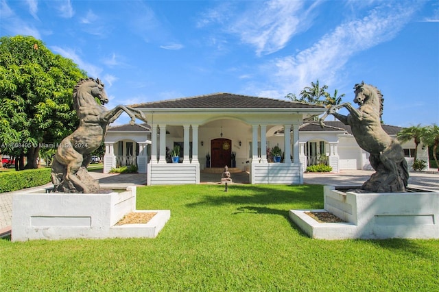 back of property featuring a lawn and covered porch