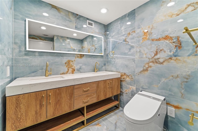 bathroom with vanity, tile walls, and toilet