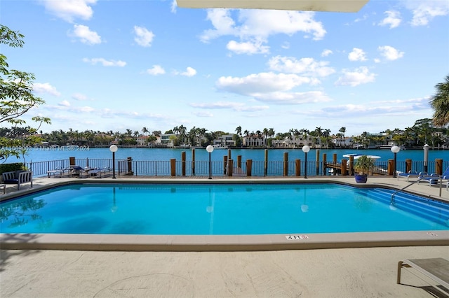 view of swimming pool with a water view