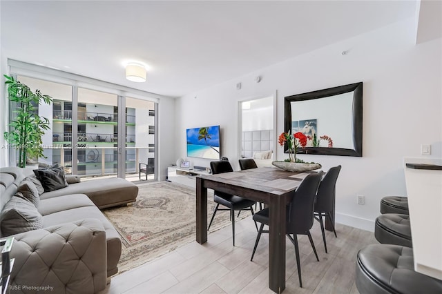 dining space with light hardwood / wood-style floors