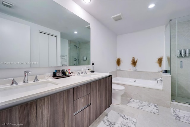 full bathroom featuring independent shower and bath, vanity, and toilet