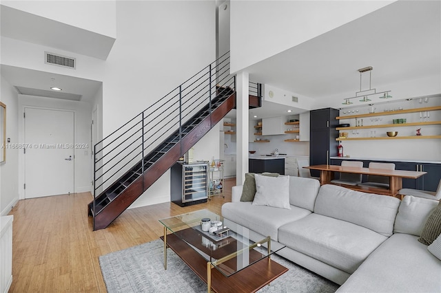 living room with light wood-type flooring and beverage cooler