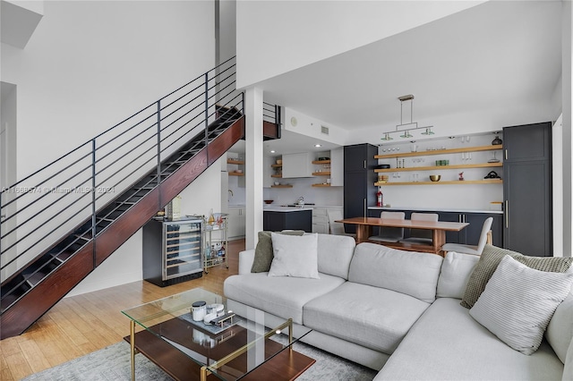 living room with beverage cooler and light hardwood / wood-style floors