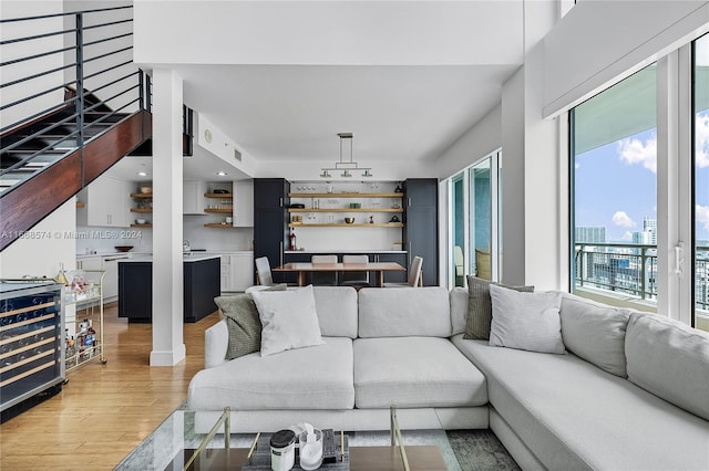 living room with beverage cooler and hardwood / wood-style floors