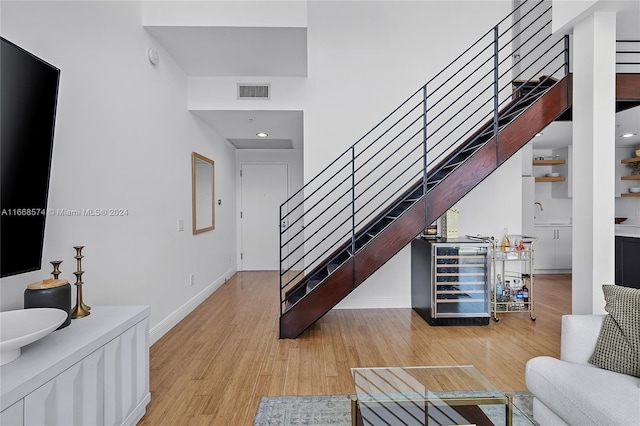 living room featuring beverage cooler and light wood-type flooring