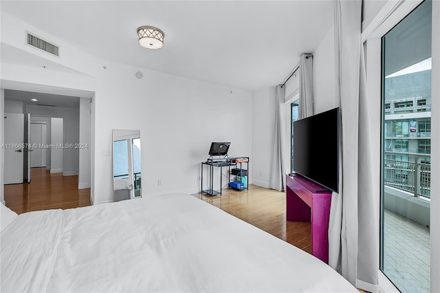 bedroom featuring hardwood / wood-style flooring and multiple windows