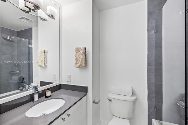 bathroom featuring walk in shower, vanity, and toilet