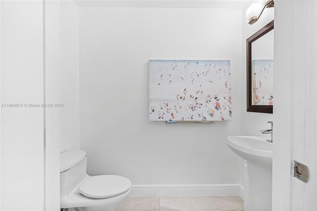 bathroom featuring toilet and tile patterned floors