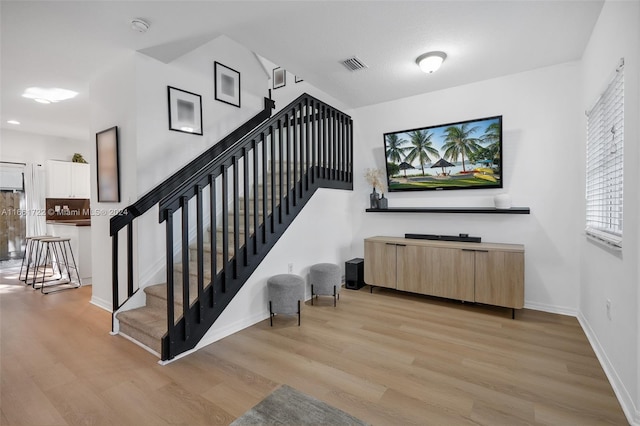 stairs featuring wood-type flooring