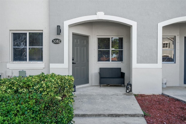 entrance to property featuring stucco siding