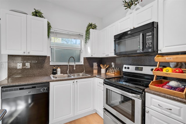 kitchen featuring black appliances, white cabinetry, and sink