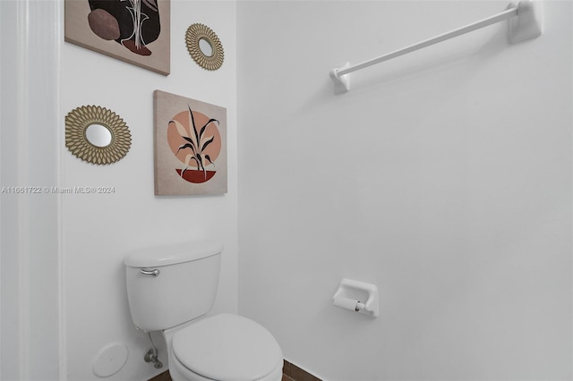 bathroom with baseboards and toilet