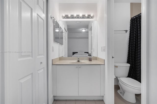 bathroom with tile patterned floors, vanity, and toilet