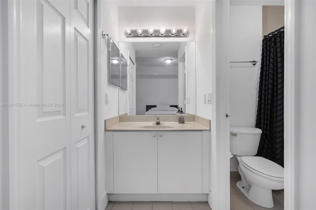bathroom with tile patterned flooring, ensuite bath, toilet, and vanity
