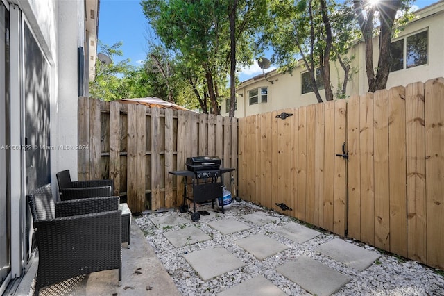 view of patio / terrace with a fenced backyard and a grill