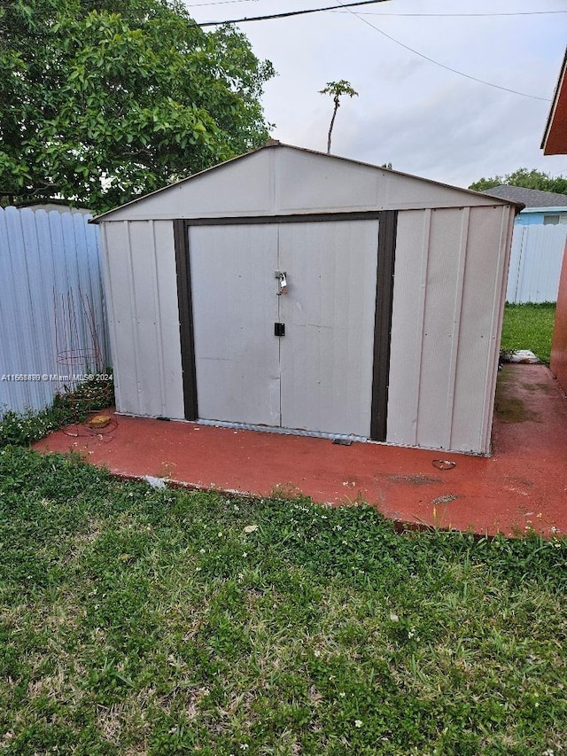 view of outbuilding featuring a lawn