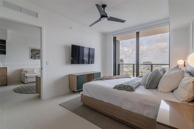 bedroom featuring ceiling fan, a wall of windows, and access to exterior